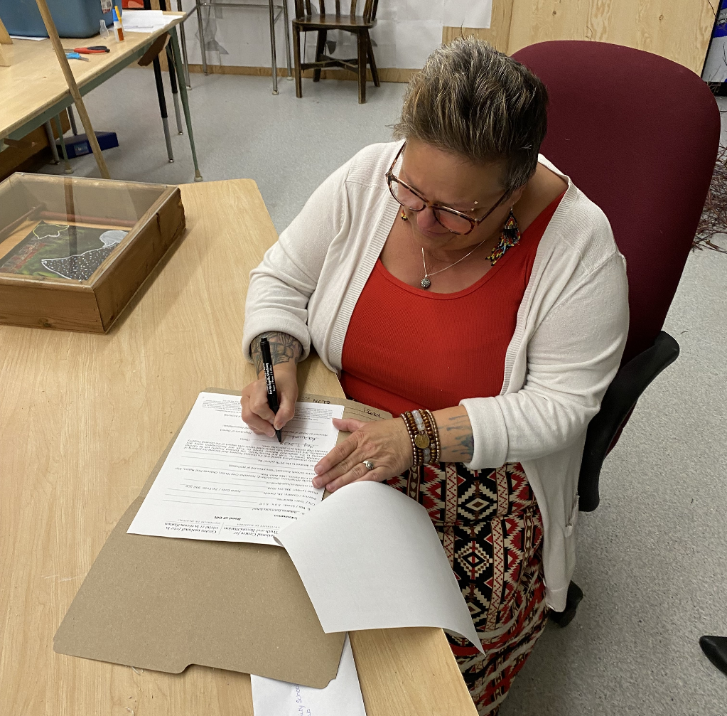 Michele signing form